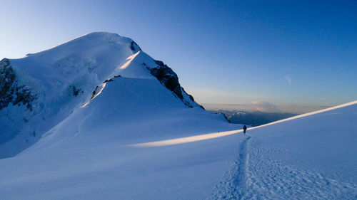 Scenic view of snowcapped mountains against clear sky