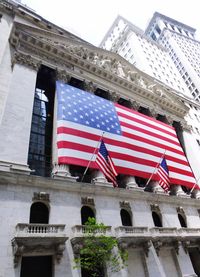 Low angle view of flag against buildings