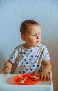 Portrait of cute boy eating at home