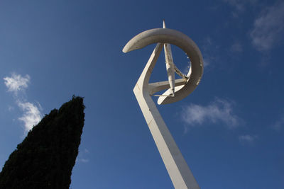 Low angle view of telephone pole against blue sky