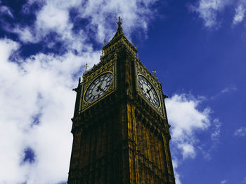 Low angle view of clock tower against sky