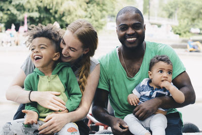 Happy family sitting at park