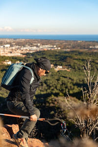 Side view of man working on field against sky