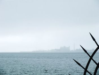 Scenic view of sea against sky in foggy weather