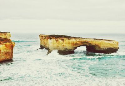 Rock formation in sea against sky at port campbell