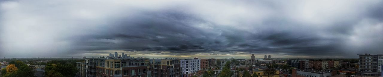 Cityscape against cloudy sky