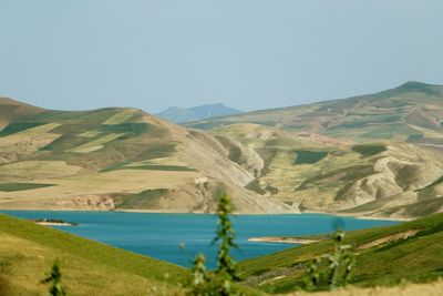 Scenic view of lake and mountains against clear sky