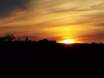 Scenic view of silhouette landscape against sky during sunset