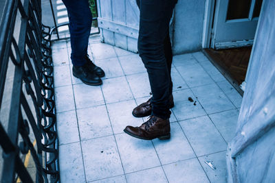 Low section of man standing on footpath