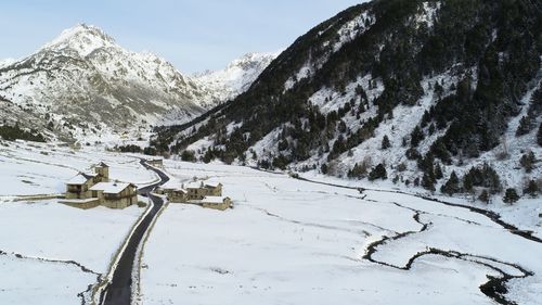 Scenic view of snow covered mountains against sky