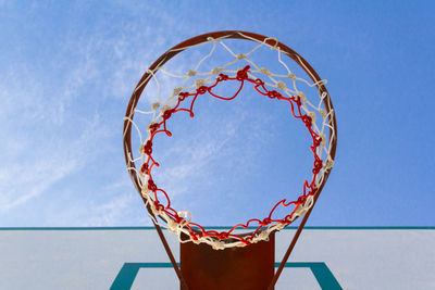 Low angle view of basketball hoop against blue sky