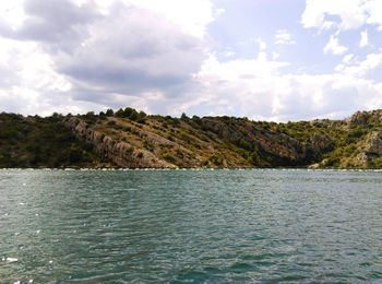 Scenic view of sea and trees against sky