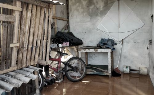 Bicycles on wooden floor against wall