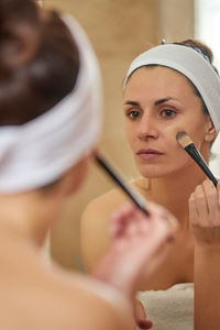 Reflection of woman in towel seen in mirror