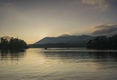 Scenic view of lake at sunset