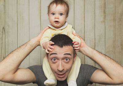 Portrait of man carrying baby on shoulders