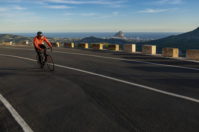 Man riding bicycle on road