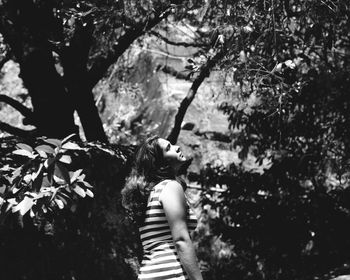 Young woman standing on tree