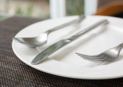 Close-up of fork in plate on table