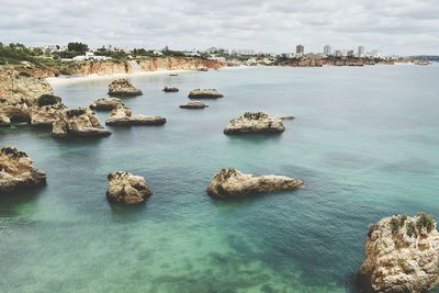 High angle view of rocks in sea against sky