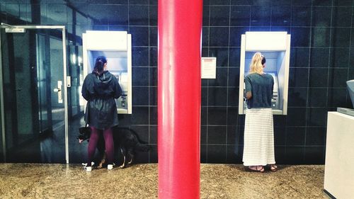 Man and woman standing by window