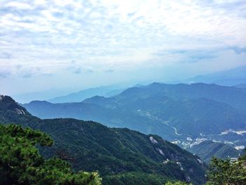 Scenic view of mountains against cloudy sky