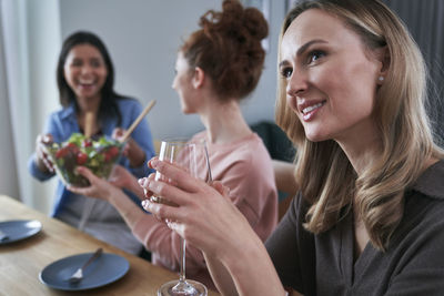 Smiling friends having food at restaurant