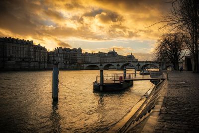 View of bridge over river against cloudy sky