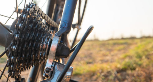 Close-up of rusty bicycle on field