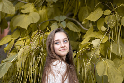 Portrait of a smiling young woman with leaves