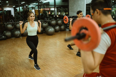 Midsection of woman exercising in gym