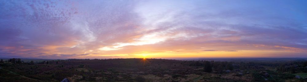 Scenic view of city against sky during sunset