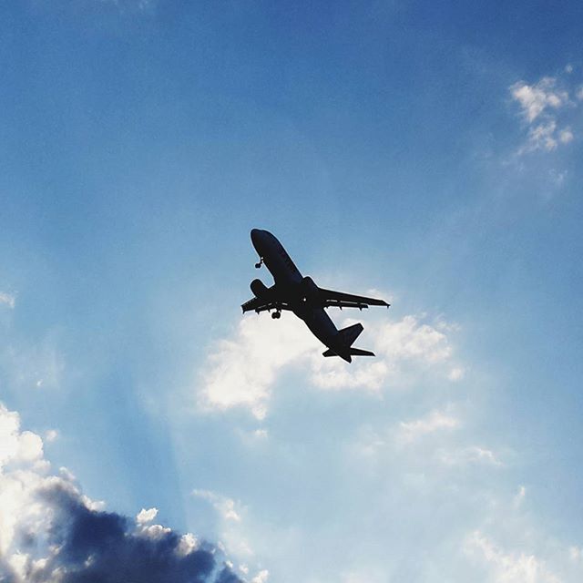 flying, low angle view, airplane, air vehicle, mid-air, transportation, mode of transport, sky, cloud - sky, on the move, blue, travel, silhouette, motion, public transportation, commercial airplane, journey, cloud, outdoors, day