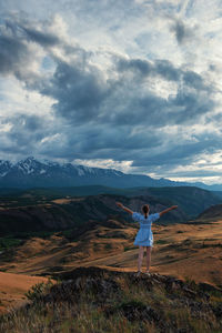 Full length rear view of man standing on mountain