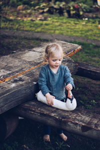 Cute baby girl playing with toy on wooden table