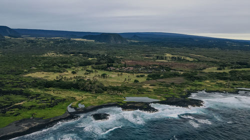 High angle view of river amidst mountains against sky