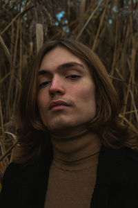 Close-up portrait of young man against plants