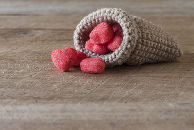 Close-up of red candies in wool sack on table
