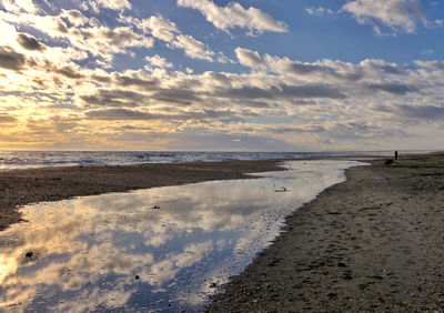 Scenic view of beach against sky during sunset