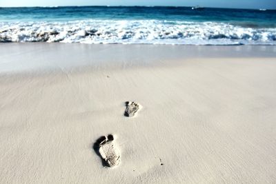 High angle view of footprint on sand at beach