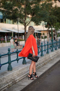 Full length of woman walking on footpath