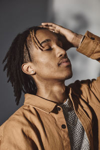 Young man with hand in hair at studio