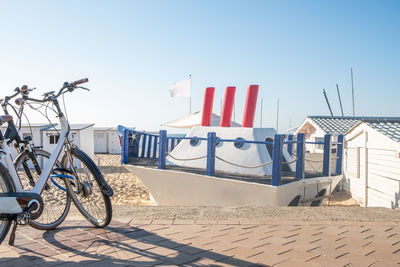 Bicycle flag on road against sky