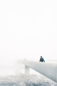 Woman on water against clear sky