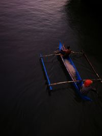 High angle view of man on boat moored in water