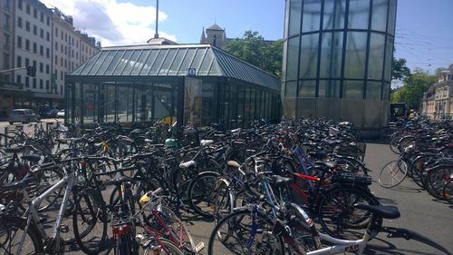 Bicycles parked in city against sky