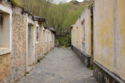 Empty alley amidst buildings