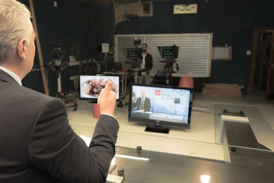 Rear view of man working on table