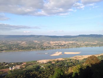 High angle view of lake by townscape against sky