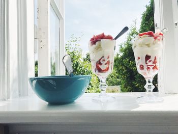 Close-up of vanilla ice cream on window sill